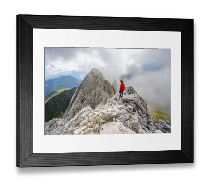 Framed Print : Mountaineer on a rocky narrow summit ridge