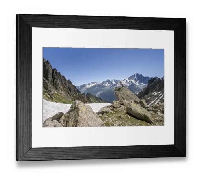 Framed Print : Mountaineer standing on a rock