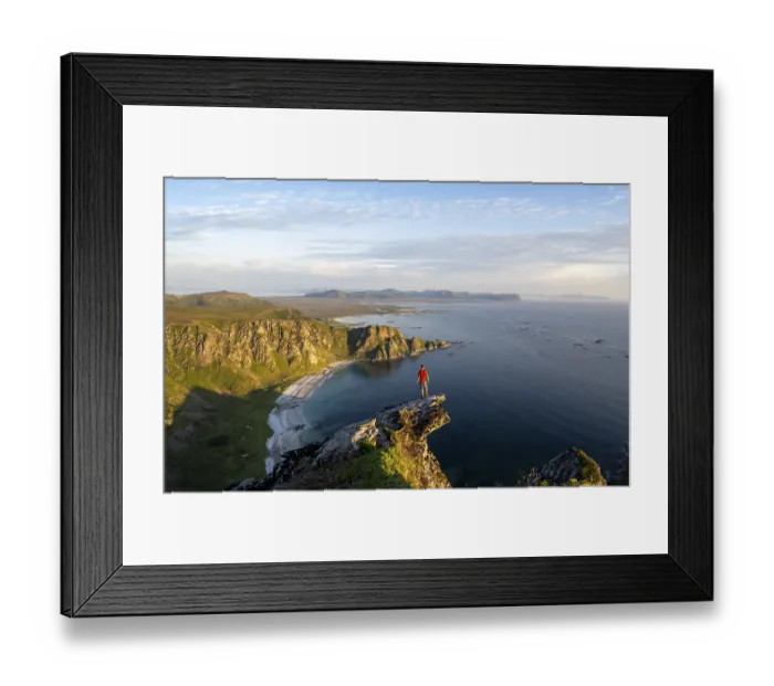 Framed Print : Evening mood, mountaineer standing on a rocky outcrop on the summit of Matind