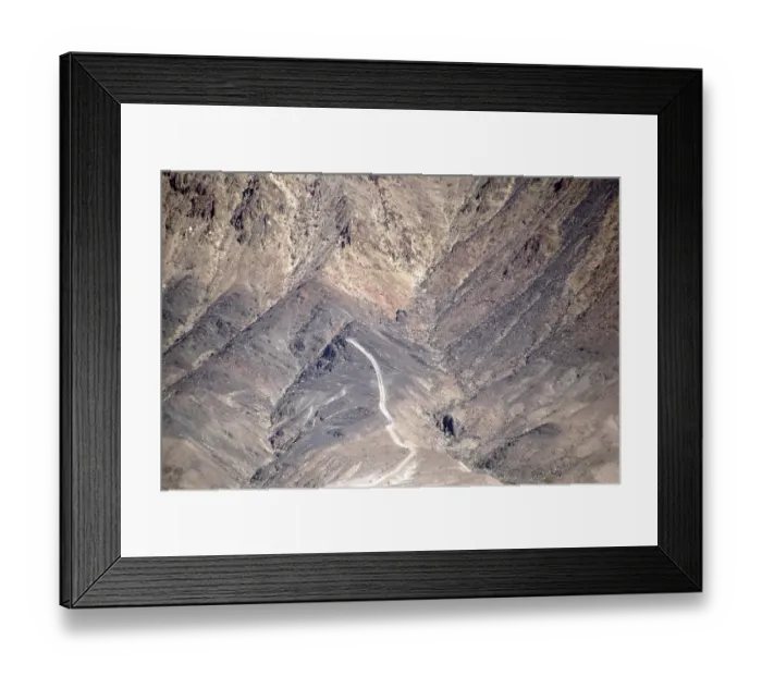 Framed Print : A road leads up a mountain consisting of several ridges