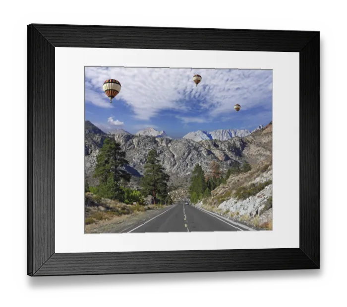 Framed Print : Huge balloons with the passenger basket flying over the magnificent American roads in the mountains
