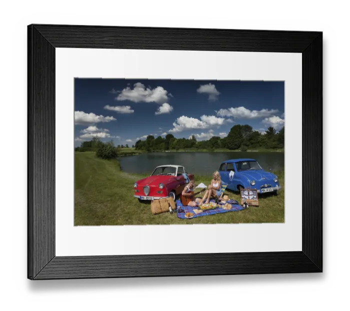 Framed Print : Two young woman having a picnic next to two vintage cars at the lake in sunny weather Framed Print : Two young woman having a picnic next to two vintage cars at the lake in sunny weather