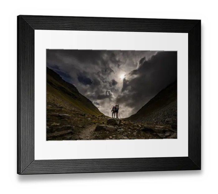 Framed Print : Val Minor with mountaineers in autumn colours with dramatic cloudy sky