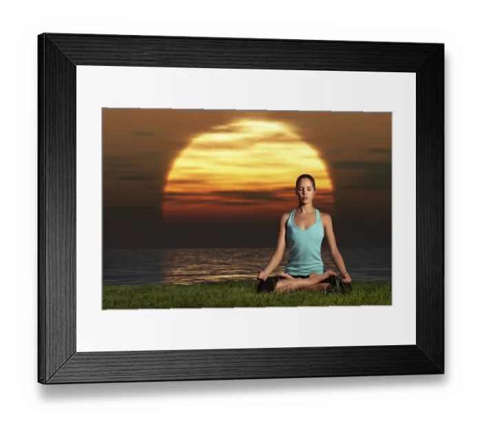 Framed Print : An athletic, beautiful woman practising yoga on the beach at dawn