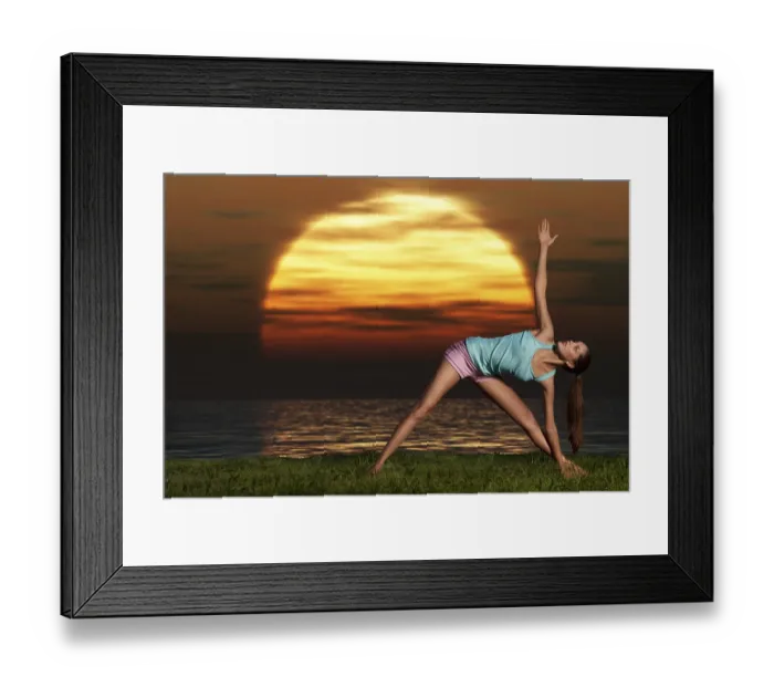 Framed Print : An athletic, beautiful woman practising yoga on the beach at dawn