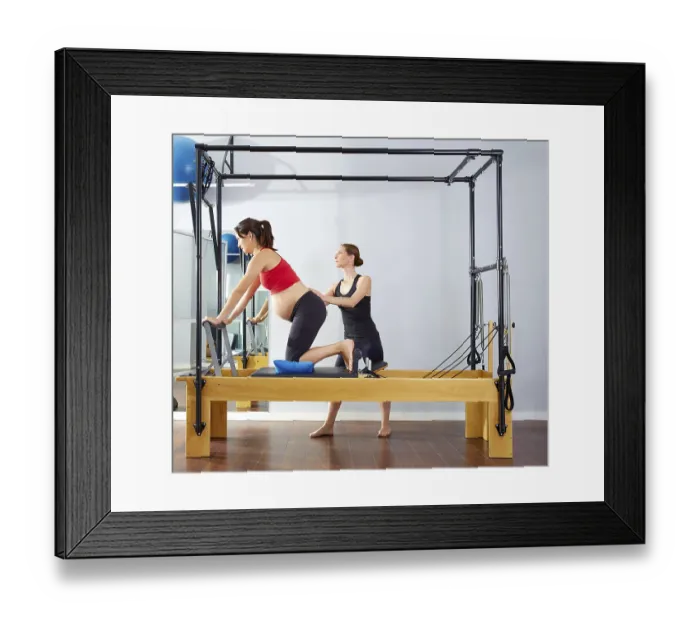 Framed Print : Pregnant woman pilates reformer cadillac exercise workout with personal trainer Framed Print : Pregnant woman pilates reformer cadillac exercise workout with personal trainer