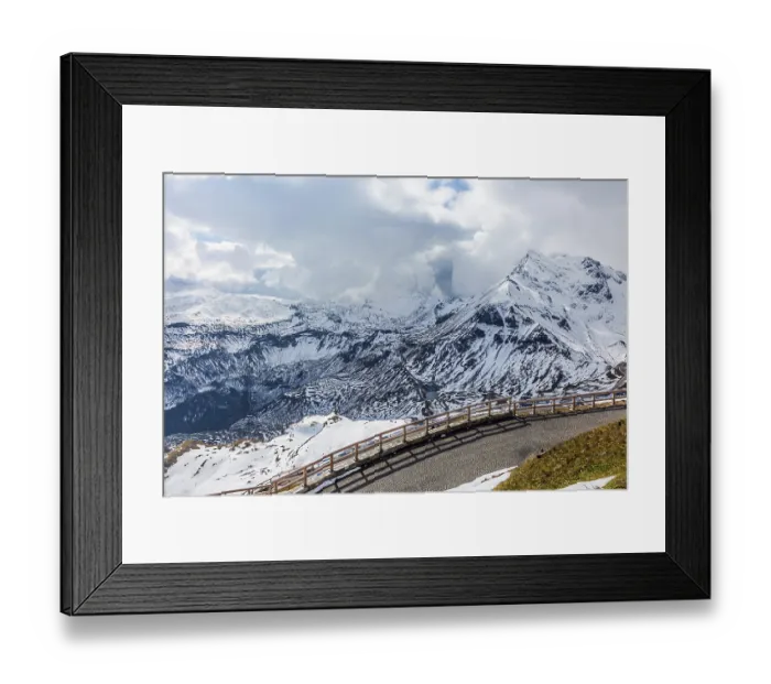 Framed Print : Abrupt turn on the wet road. The snow on the mountainside began to melt Framed Print : Abrupt turn on the wet road. The snow on the mountainside began to melt