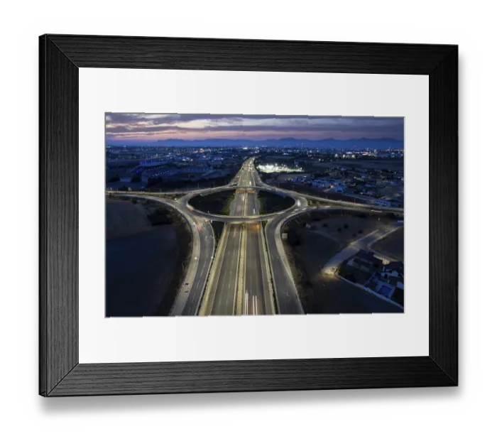 Framed Print : Aerial drone top view of a modern motorway junction roundabout with cars moving fast Framed Print : Aerial drone top view of a modern motorway junction roundabout with cars moving fast