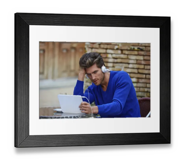 Framed Print : Young man with tablet pc touch in an cafe outdoor sitting Framed Print : Young man with tablet pc touch in an cafe outdoor sitting