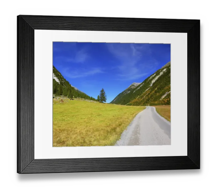 Framed Print : Sunny autumn day. Wide dirt road in an Alpine valley