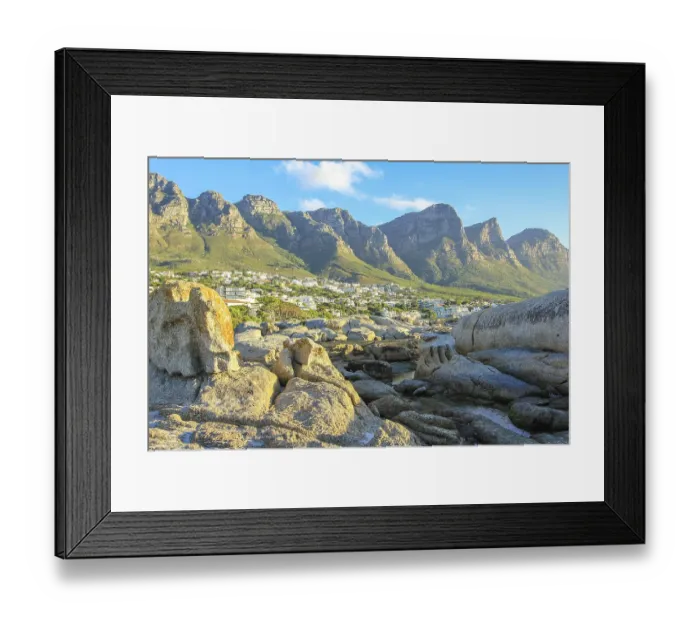 Framed Print : Big rocks in Camps Bay with Table Mountain National Park behind him