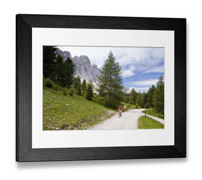 Framed Print : Cyclist beneath Mt Geislerspitzen in Villnoesstal valley Framed Print : Cyclist beneath Mt Geislerspitzen in Villnoesstal valley