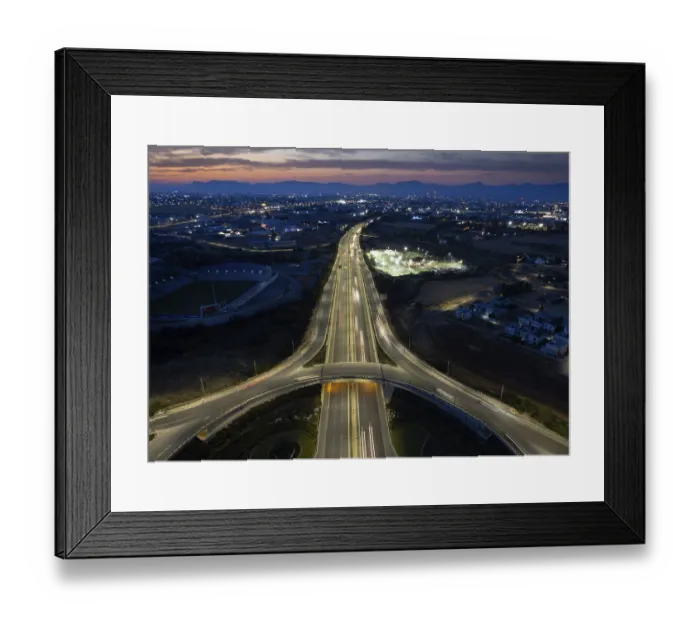 Framed Print : Aerial drone top view of a modern motorway junction roundabout with cars moving fast Framed Print : Aerial drone top view of a modern motorway junction roundabout with cars moving fast