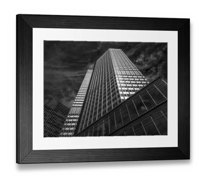 Framed Print : Dramatic black and white view of a modern tower block under a cloudy sky