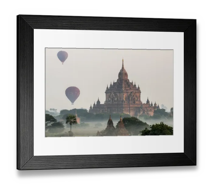 Framed Print : Hot air balloons over the landscape in the early morning fog