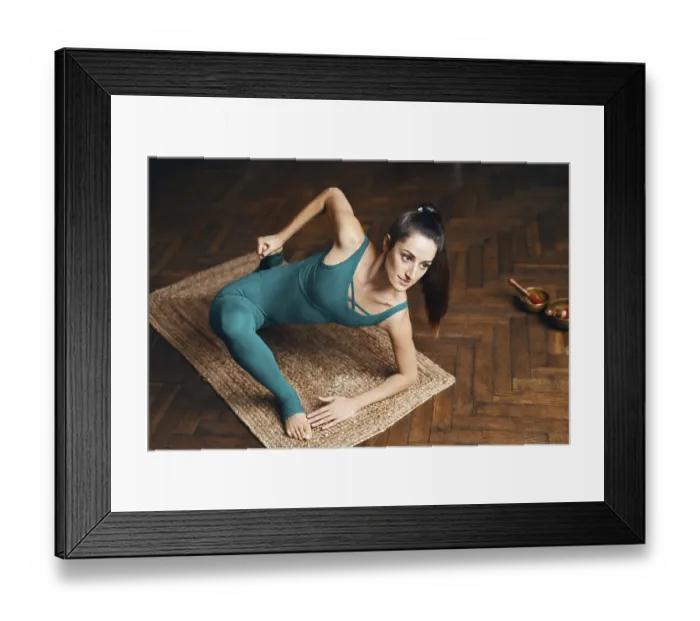 Framed Print : Young slim woman practicing yoga doing lizard pose asana at home