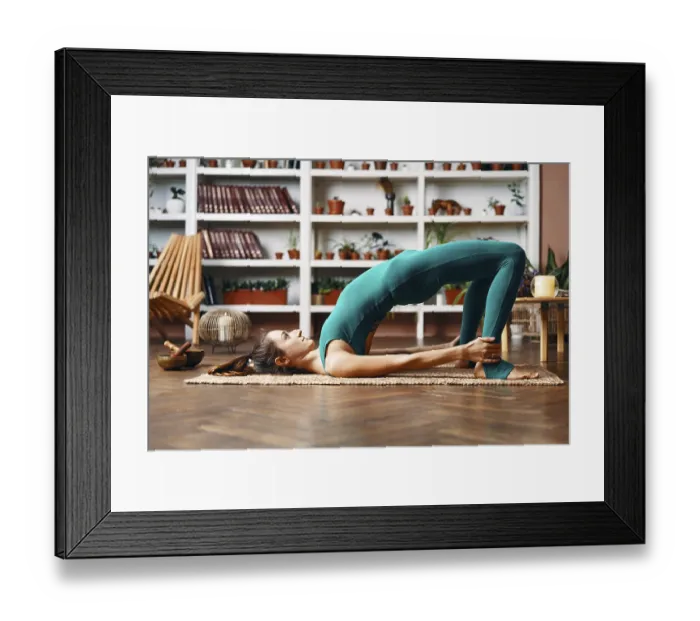 Framed Print : Young woman practicing yoga doing bridge pose