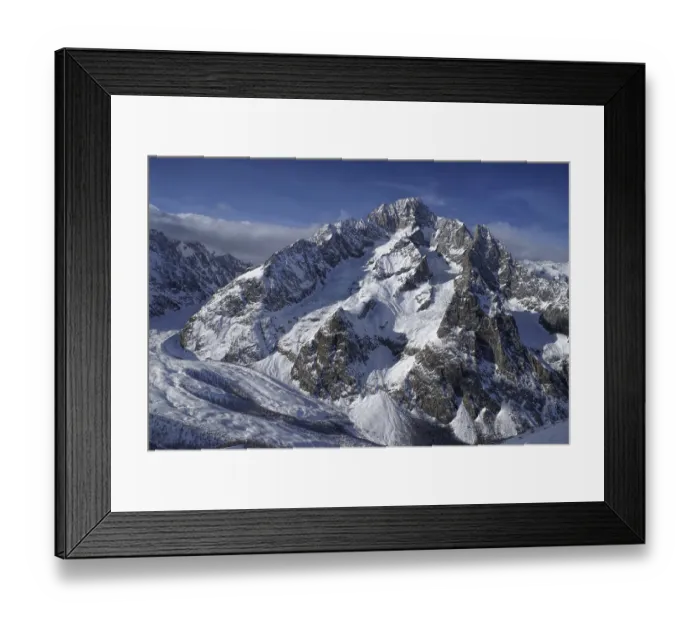 Framed Print : Close-up view of a high mountain covered in snow illuminated by the setting sun Framed Print : Close-up view of a high mountain covered in snow illuminated by the setting sun