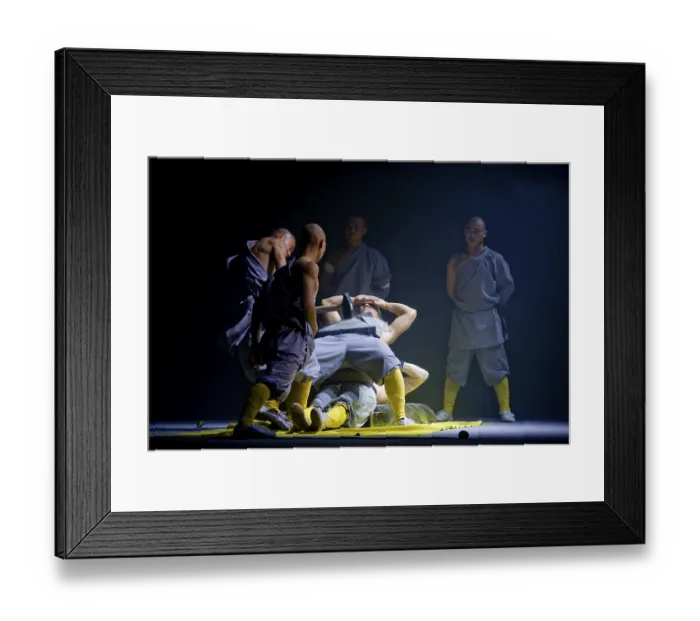 Framed Print : A concrete slab is being smashed on a monk while he is lying on a bed of nails