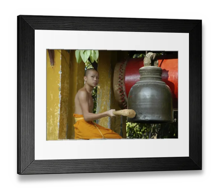 Framed Print : Young buddhist monk ringing the bell Framed Print : Young buddhist monk ringing the bell