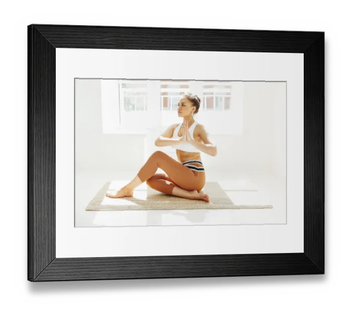 Framed Print : ????? female in sportswear sitting with crossed legs and on mat and doing yoga while practicing mindfulness