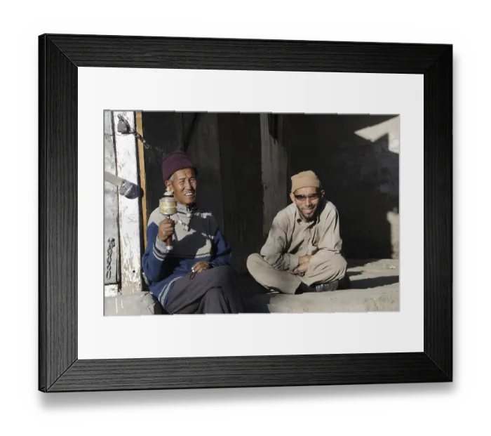 Framed Print : Buddhist Ladakhis with prayer wheel in front of a shop in Leh