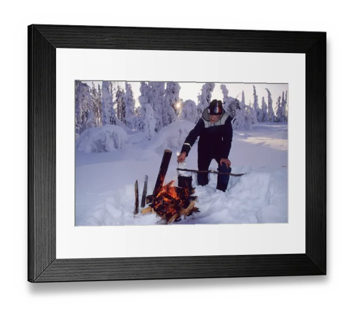 Framed Print : Man lighting campfire in taiga, Finland, Europe Framed Print : Man lighting campfire in taiga, Finland, Europe