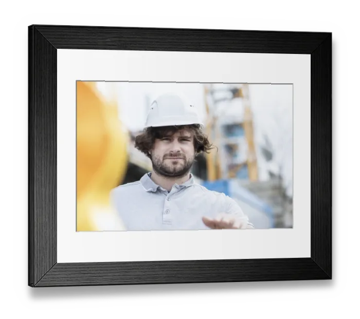 Framed Print : Technician with beard middle aged and wearing polo shirt and helmet outside at work Framed Print : Technician with beard middle aged and wearing polo shirt and helmet outside at work