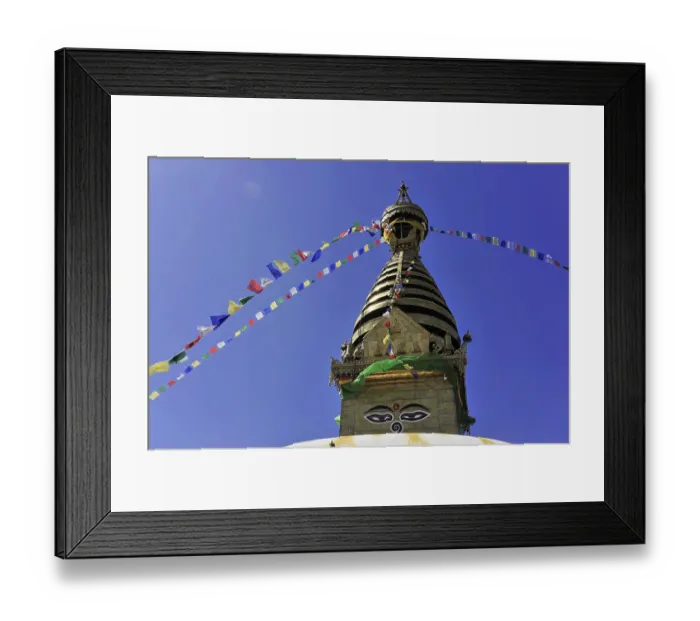 Framed Print : A stupa with colourful prayer flags in front of a clear blue sky