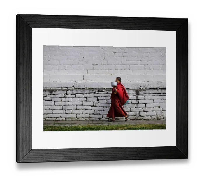 Framed Print : Monk walking through the monastery courtyard in Jampey Lhakhang Temple