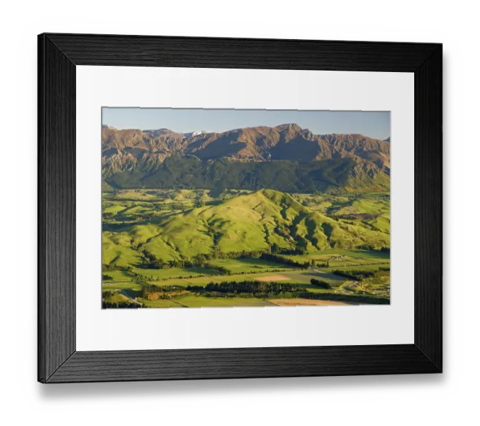 Framed Print : Green hills and meadows illuminated by warm morning light near Queenstown seen from the Remarkables