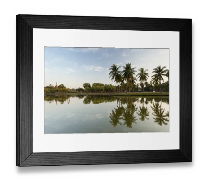 Framed Print : Chedi with palm trees and reflection in water Framed Print : Chedi with palm trees and reflection in water