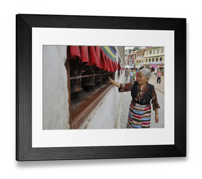 Framed Print : Pilgrim walking around stupa of Boudhanath and turning prayer wheel Framed Print : Pilgrim walking around stupa of Boudhanath and turning prayer wheel