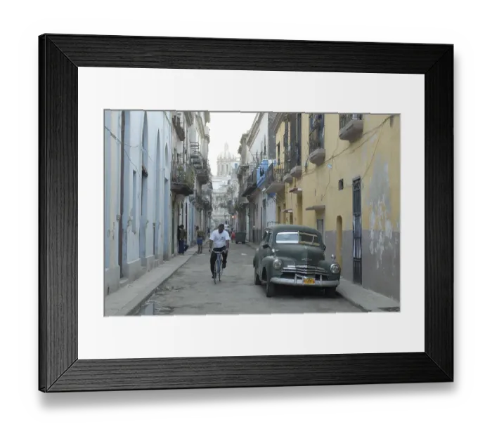 Framed Print : Vintage car and cyclist in an alley in the old part of Havana