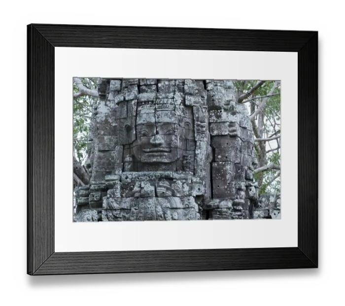 Framed Print : Stone sculpture, face of Bodhisattva Lokeshvara on a monumental tower in the Ta Som Buddhist Temple