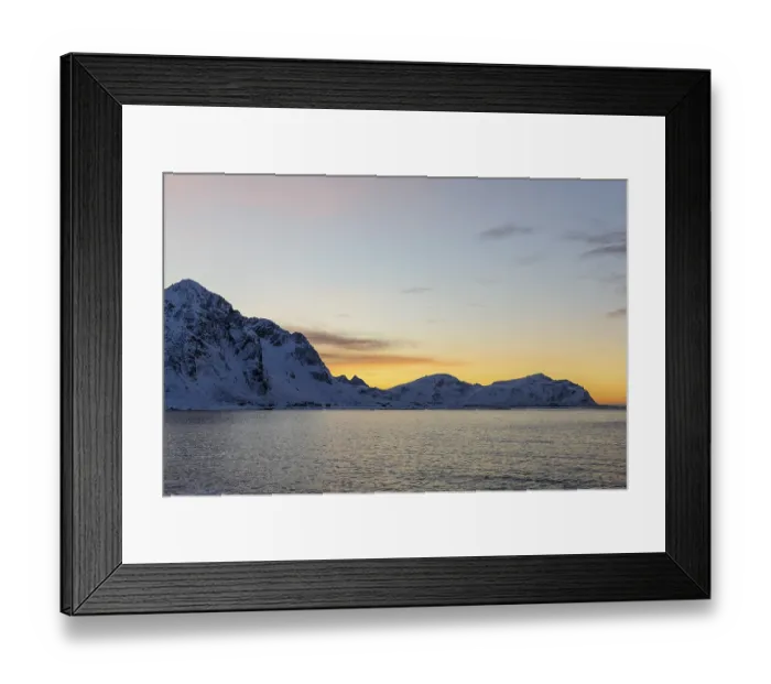 Framed Print : Snowy coastal landscape at sunset