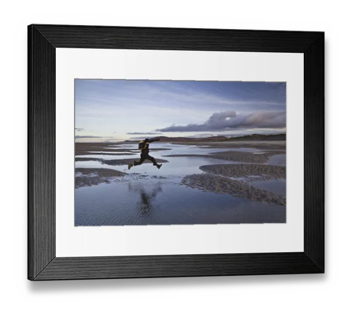 Framed Print : Man jumping over tidal sea puddles Framed Print : Man jumping over tidal sea puddles