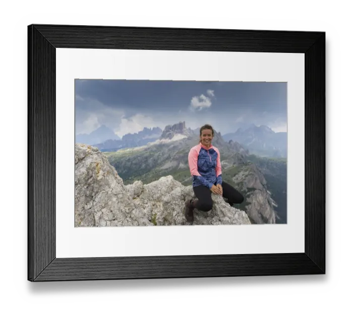 Framed Print : An attractive brunette mountain climber sitting on a mountain peak and smiling Framed Print : An attractive brunette mountain climber sitting on a mountain peak and smiling