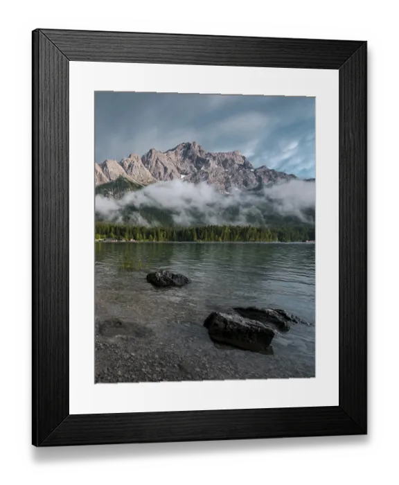 Framed Print : Rocks on the shore, Eibsee lake in front of Zugspitze massif with Zugspitze