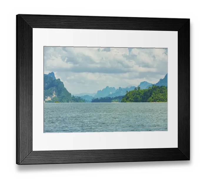 Framed Print : Distant mountains on a cloudy horizon overlook a vast lake