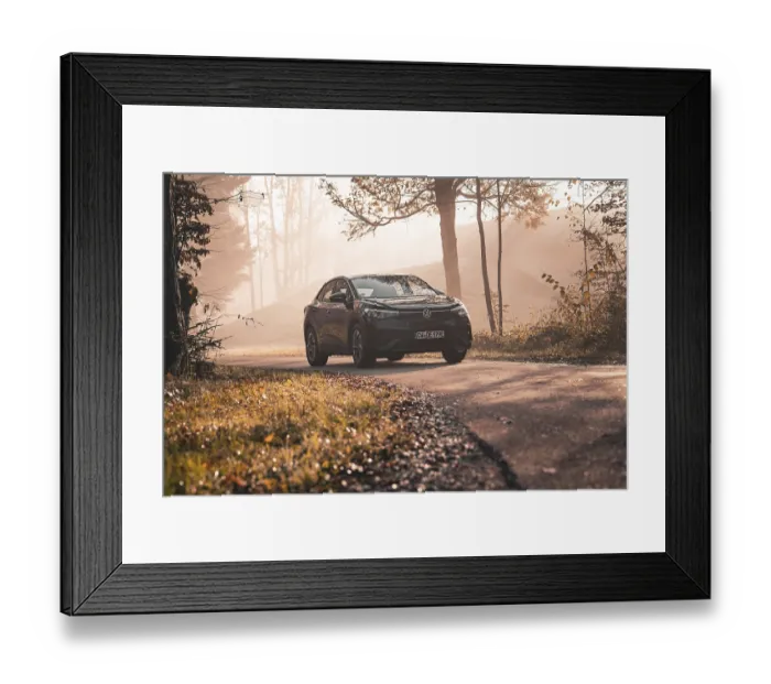 Framed Print : A car drives along a foggy forest path surrounded by autumn trees in the morning Framed Print : A car drives along a foggy forest path surrounded by autumn trees in the morning