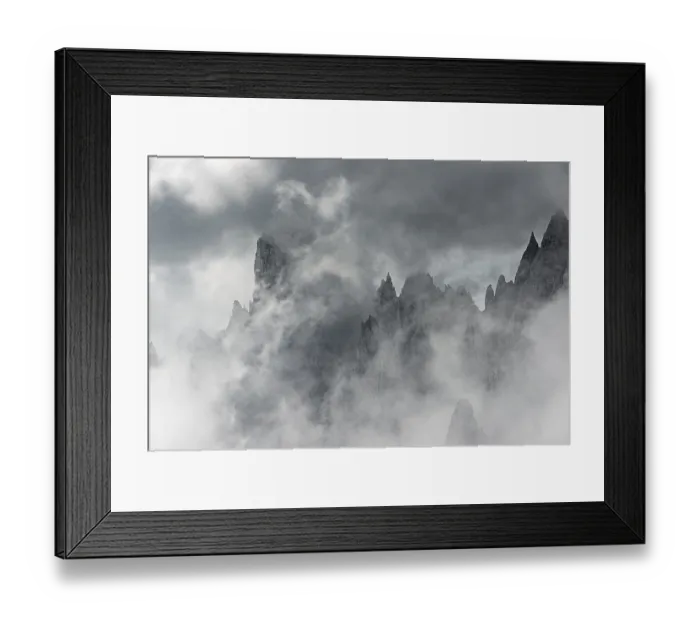 Framed Print : Bizarre mountain peaks with dramatic clouds