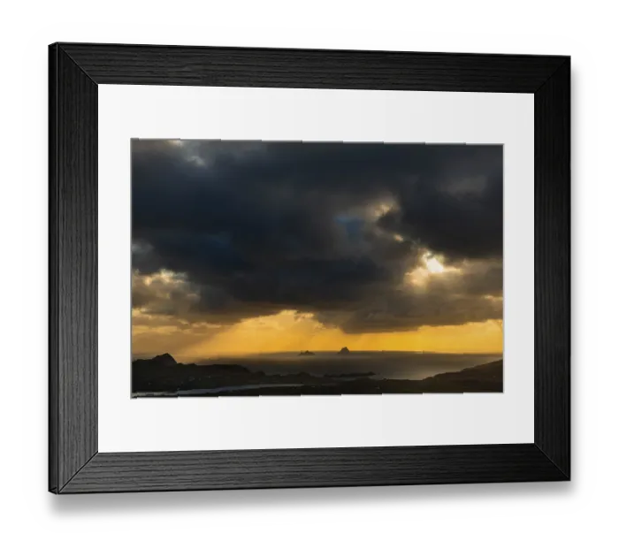 Framed Print : Seashore with the mountain peaks of the Skelligs in the background and dramatic cloudy sky