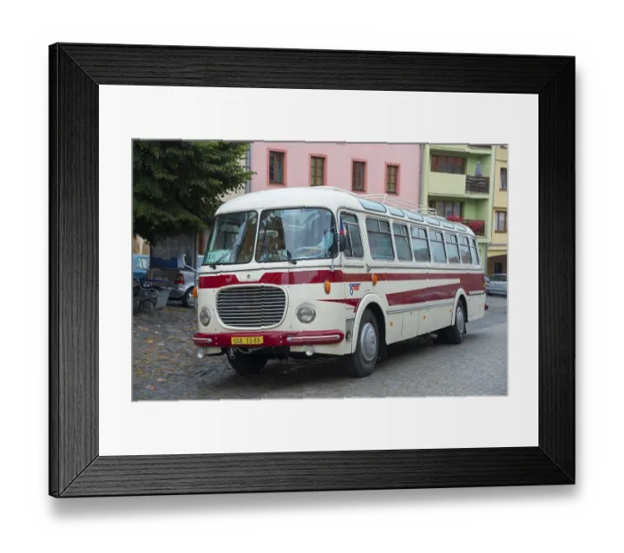 Framed Print : A classic old bus on a cobbled street in a town with colourful buildings Framed Print : A classic old bus on a cobbled street in a town with colourful buildings