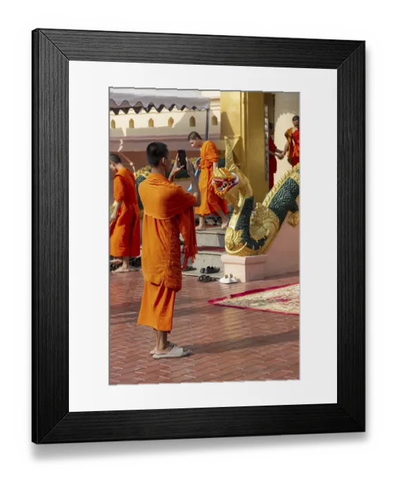 Framed Print : Monk in front of a Buddha statue