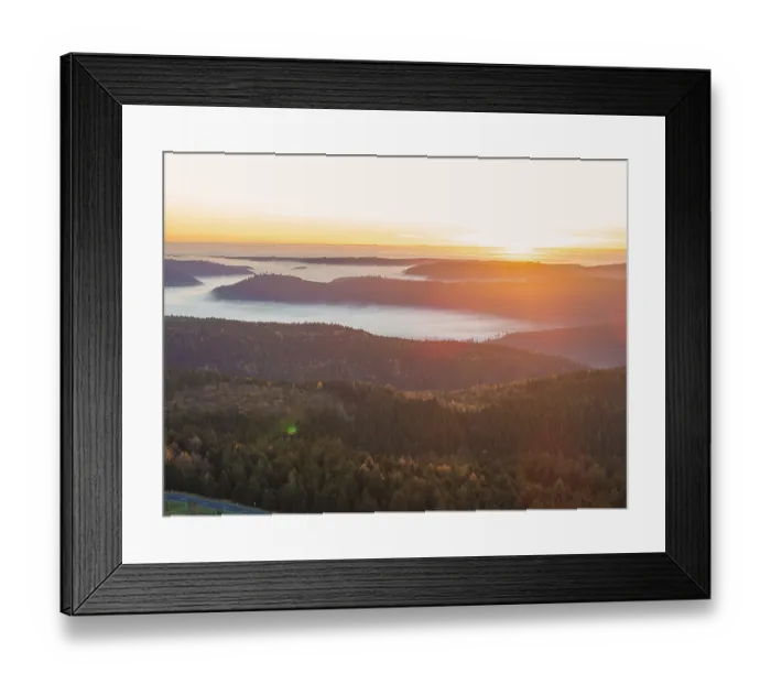 Framed Print : Sunbeams bathe the mountains in warm light