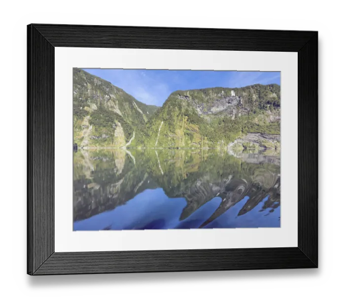 Framed Print : Mountains with reflections in the water against a blue sky in Doubtful Sound