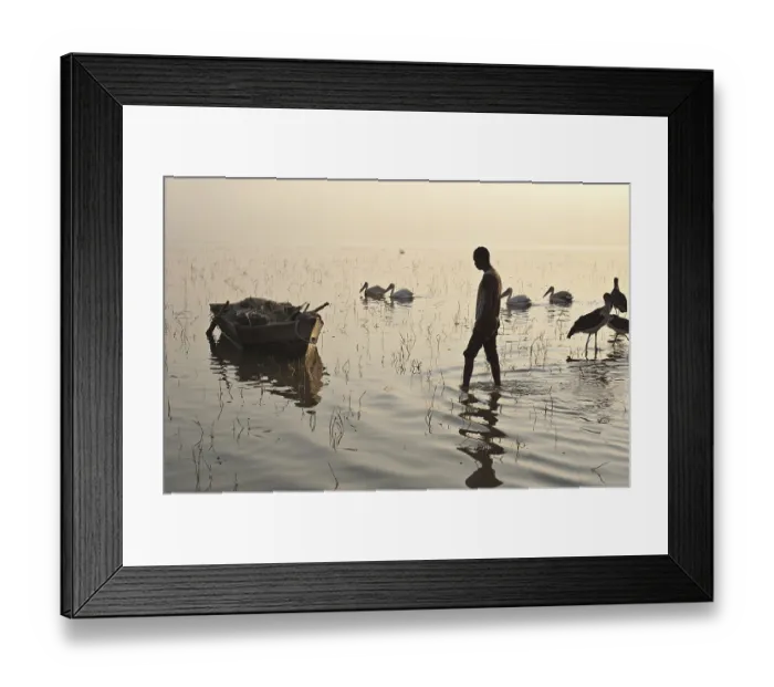Framed Print : Fisherman walking to his boat before going to fish