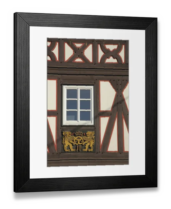 Framed Print : Wood carving with lion figures and pretzel on half-timbered house Framed Print : Wood carving with lion figures and pretzel on half-timbered house