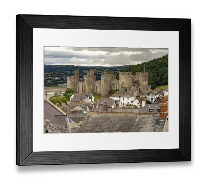 Framed Print : Conwy Castle and the roofs of the old town centre in Conwy